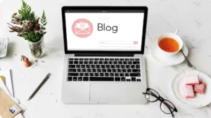 Open blog on laptop with tea and cookies